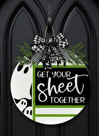 A circular Halloween-themed door hanger with the text 'GET YOUR SHEET TOGETHER'